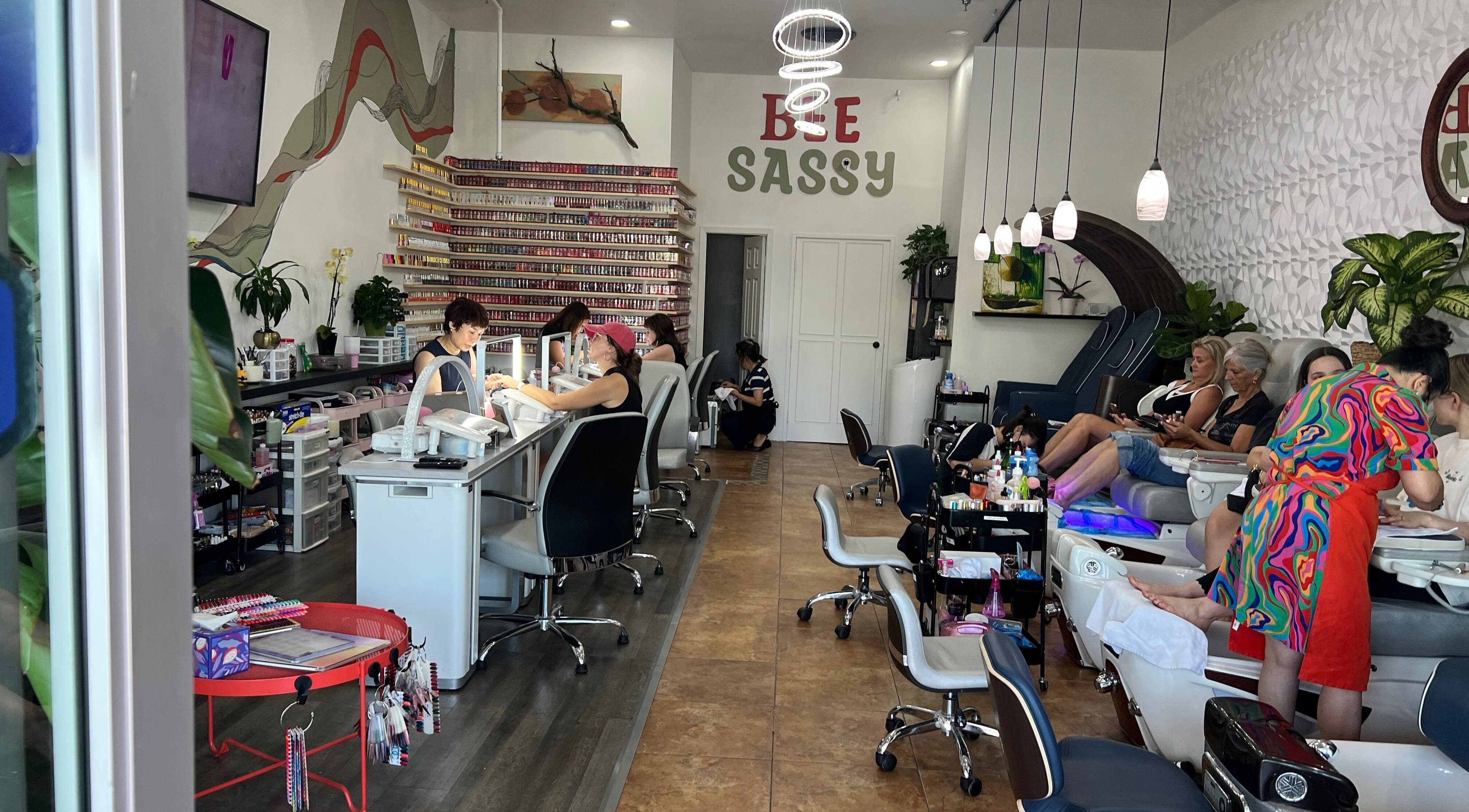 Interior of Bee Sassy Nails in Rocklin, California, US, showcasing nail stations and modern decor.