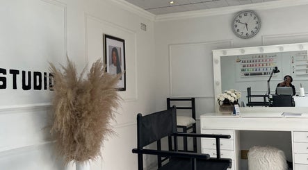 Elegant interior of Shira Glam Studio, Roodepoort, Gauteng, ZA, featuring modern decor and beauty workstations.