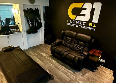 CLINIC 31 - SPORTS MASSAGE THERAPY & HIJAMA CUPPING treatment room in Birmingham, England, GB, featuring comfortable seating.