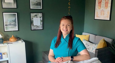 Therapist in teal uniform at Balanced Soul Therapies, Belfast, Northern Ireland, GB, in a calming room.