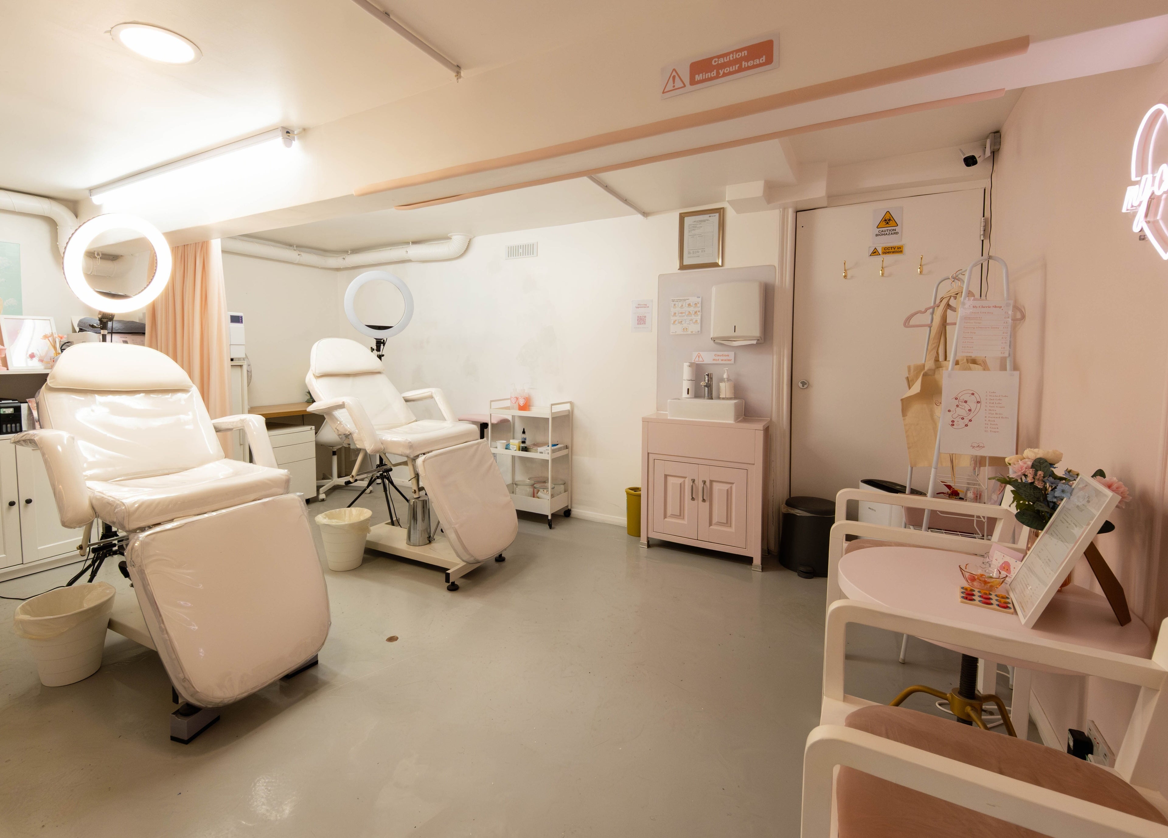 Bright, serene beauty treatment room at My Cherie Studio in London, England, GB, featuring plush chairs and soft lighting.