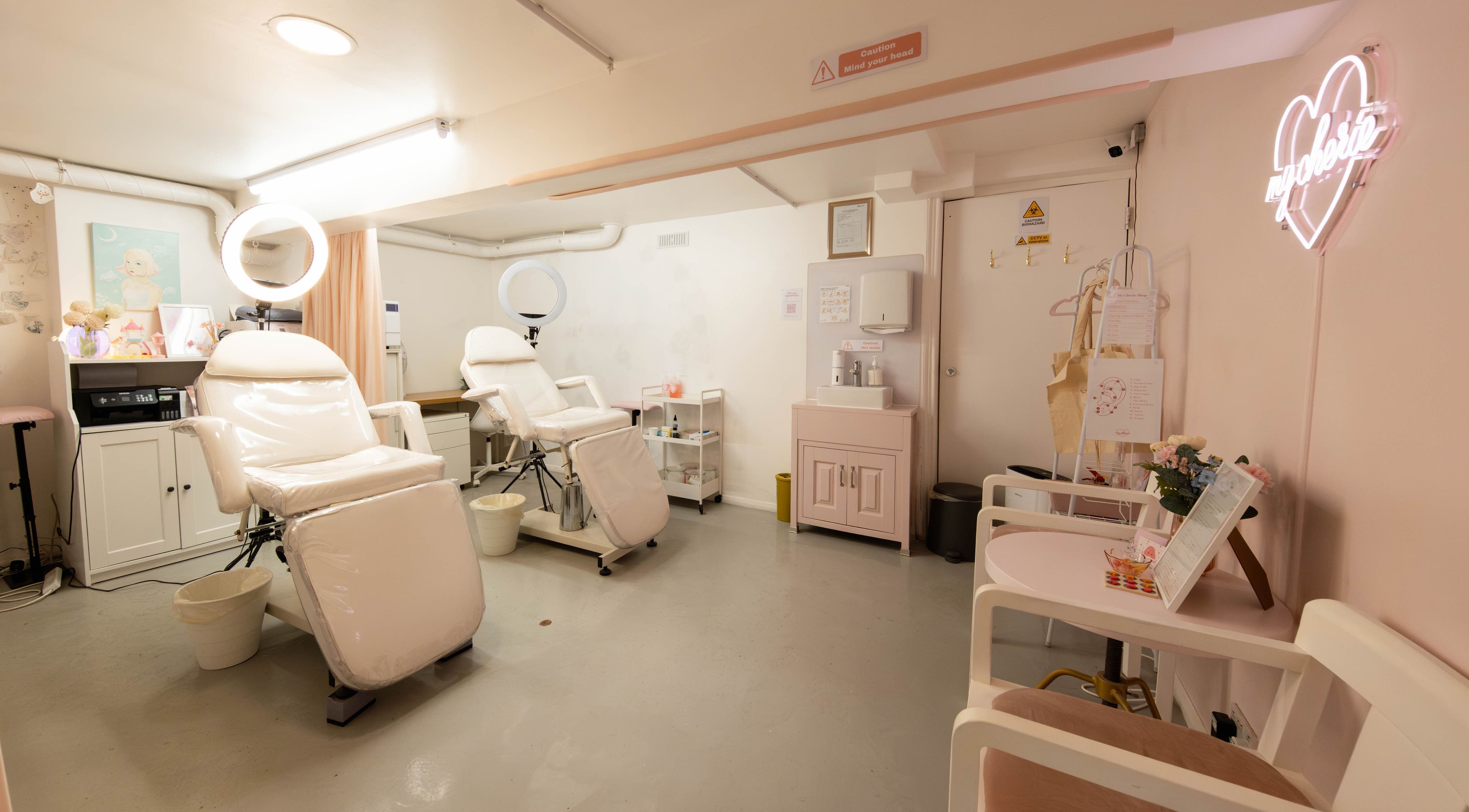 Bright, serene beauty treatment room at My Cherie Studio in London, England, GB, featuring plush chairs and soft lighting.