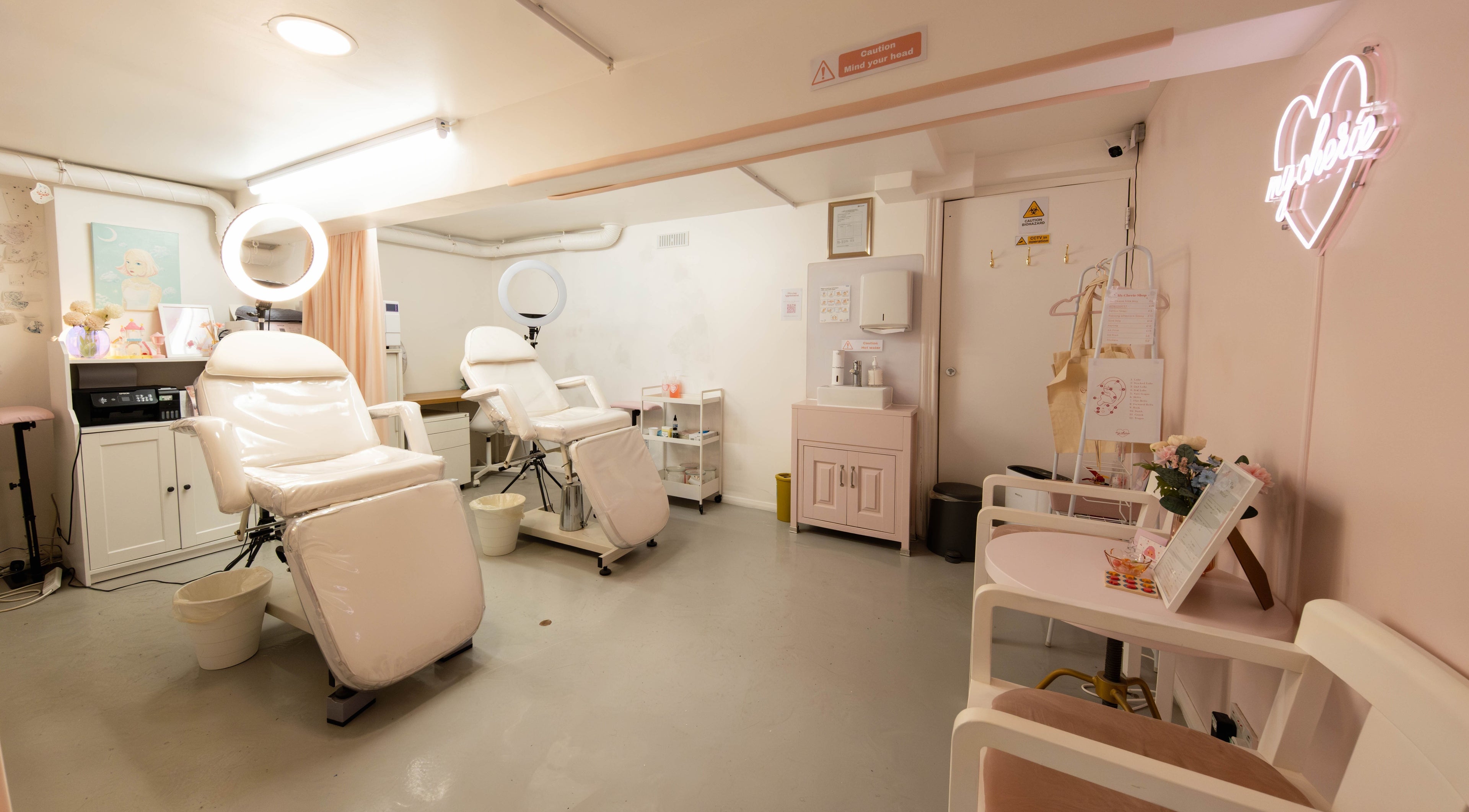 Bright, serene beauty treatment room at My Cherie Studio in London, England, GB, featuring plush chairs and soft lighting.