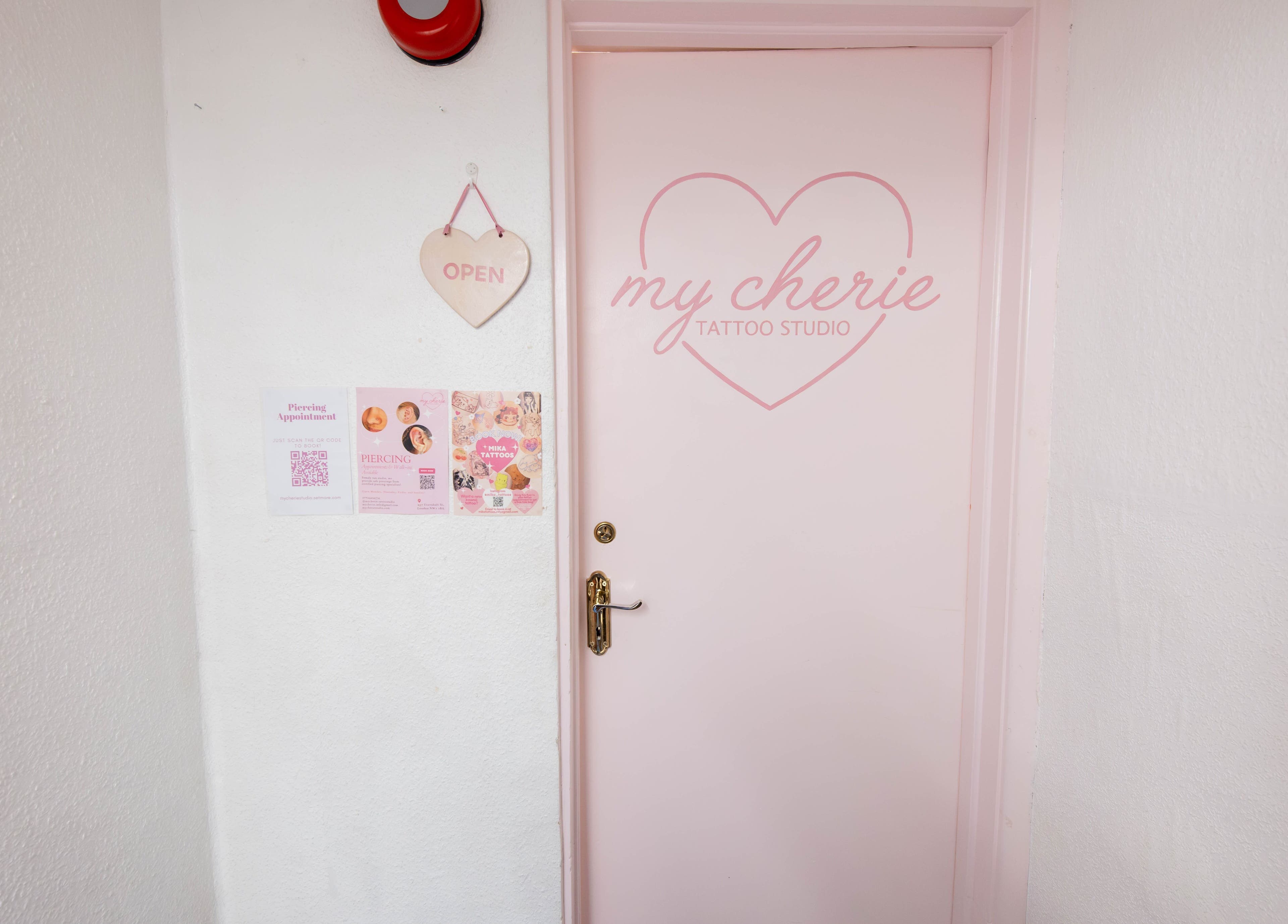 Entrance of My Cherie Studio in London, England, GB with pink door and heart decor.