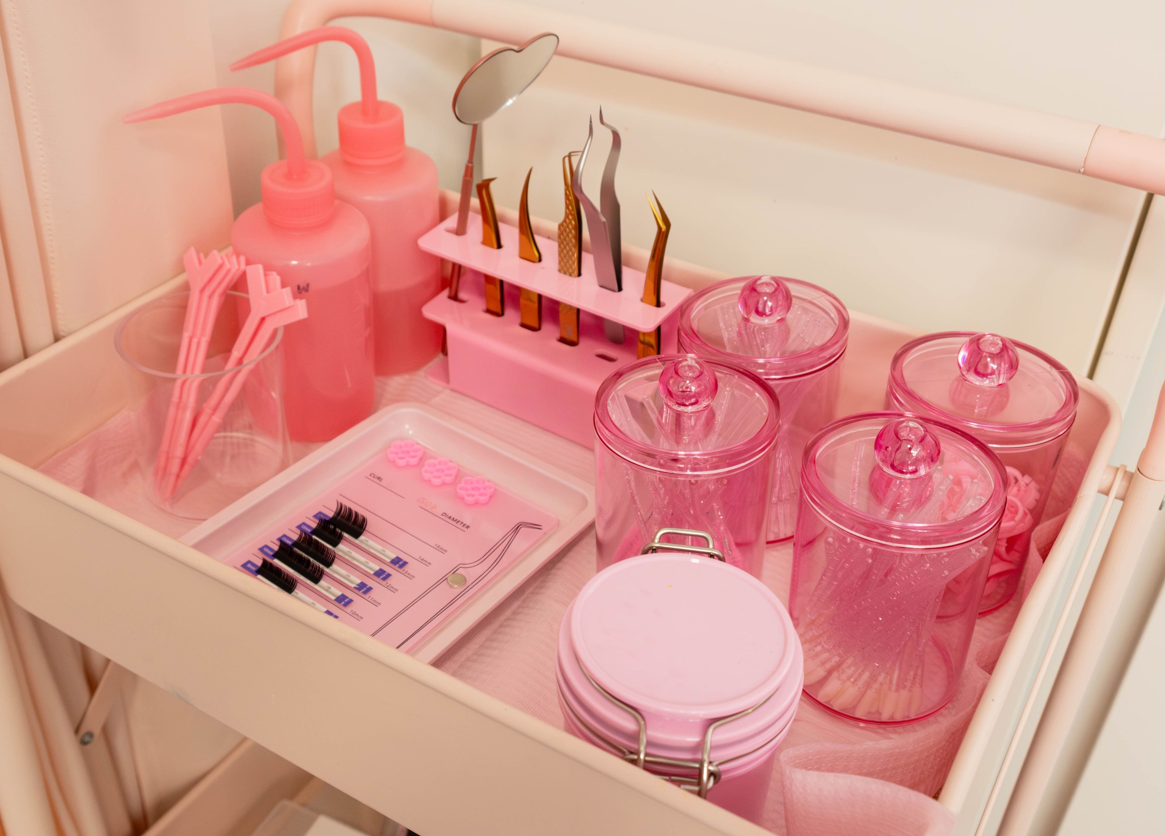Pink beauty cart with tools at My Cherie Studio, London, England, GB - a stylish setup for wellness services.