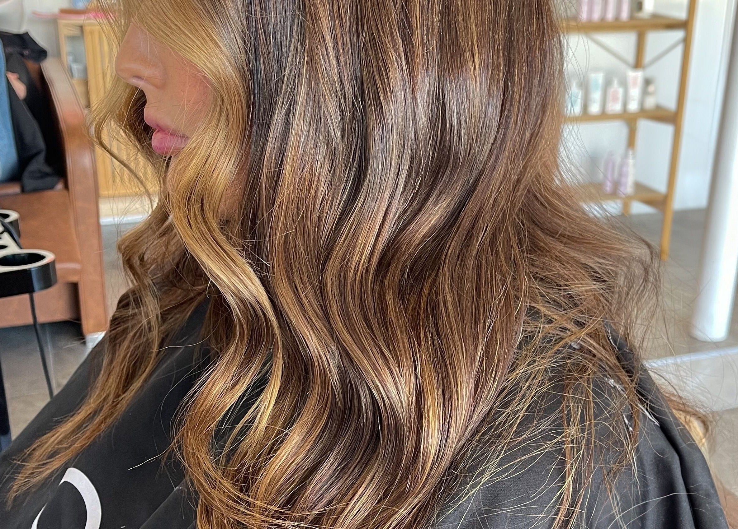 Elegant wavy hairstyle at Hair by Cher, Mooloolaba, Queensland, AU showcasing lustrous layers.