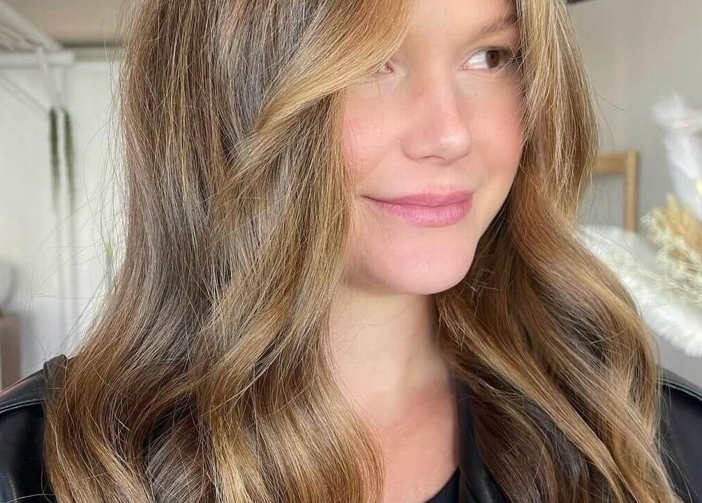 Woman with golden waves at Hair by Cher, Mooloolaba, Queensland, AU.