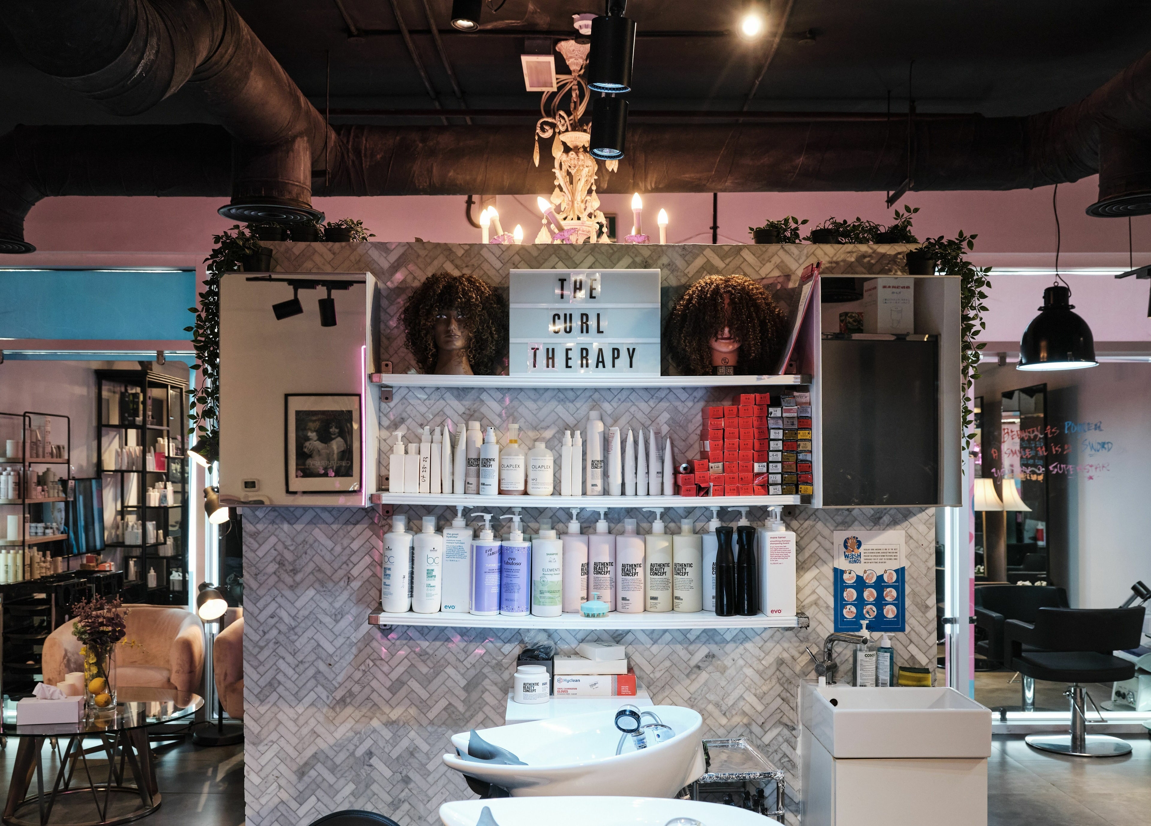 Interior of The Curl Therapy salon in Dubai, Dubai, AE featuring hair products and styling stations.