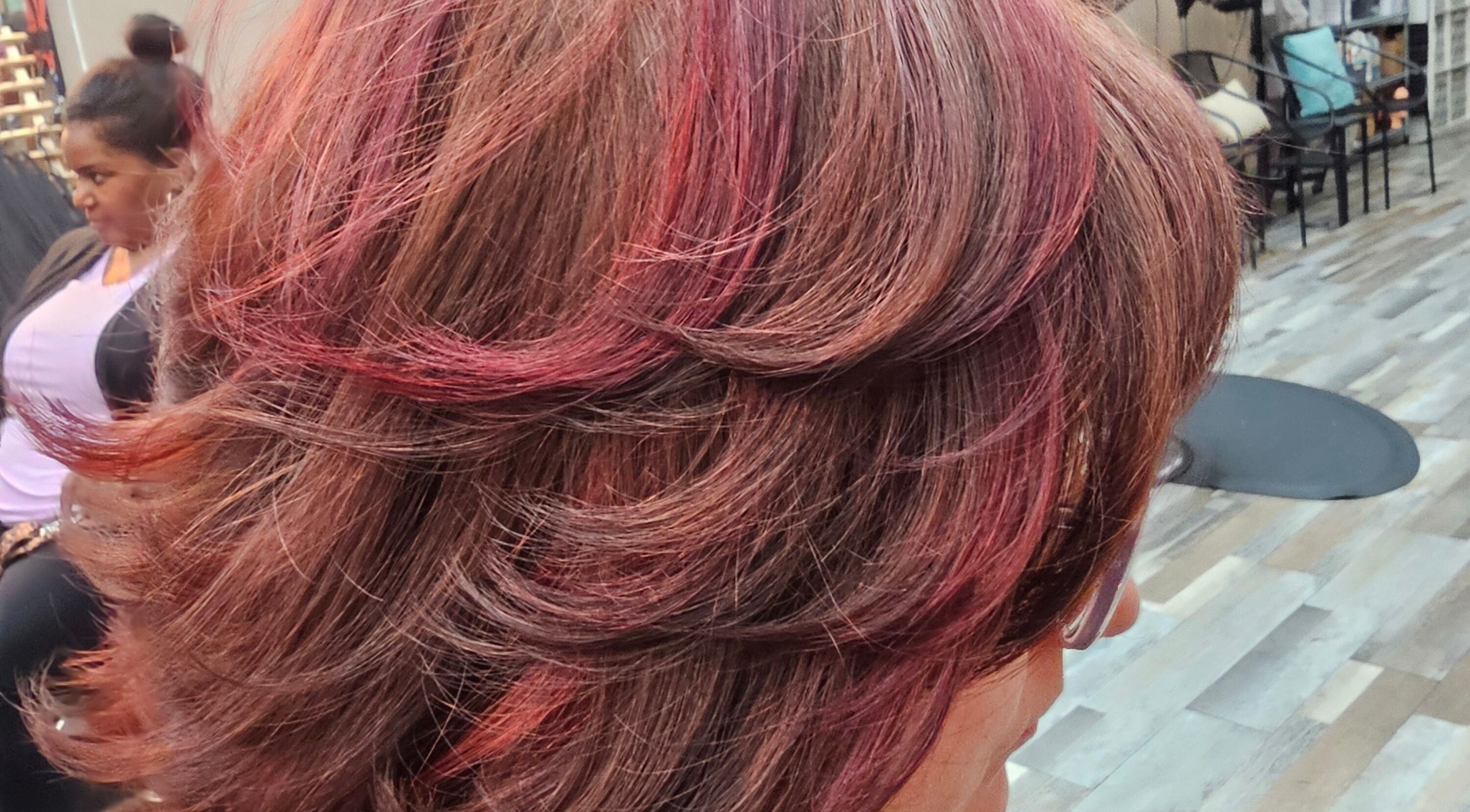 Elegant red-tinted hairstyle at Karla, Fort Worth, Texas, US, showcasing vibrant color and expert styling.