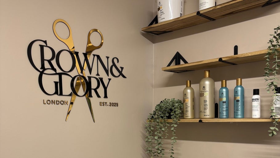 Crown and Glory salon in Wembley, England, GB showcases elegant products and decor on wooden shelves.