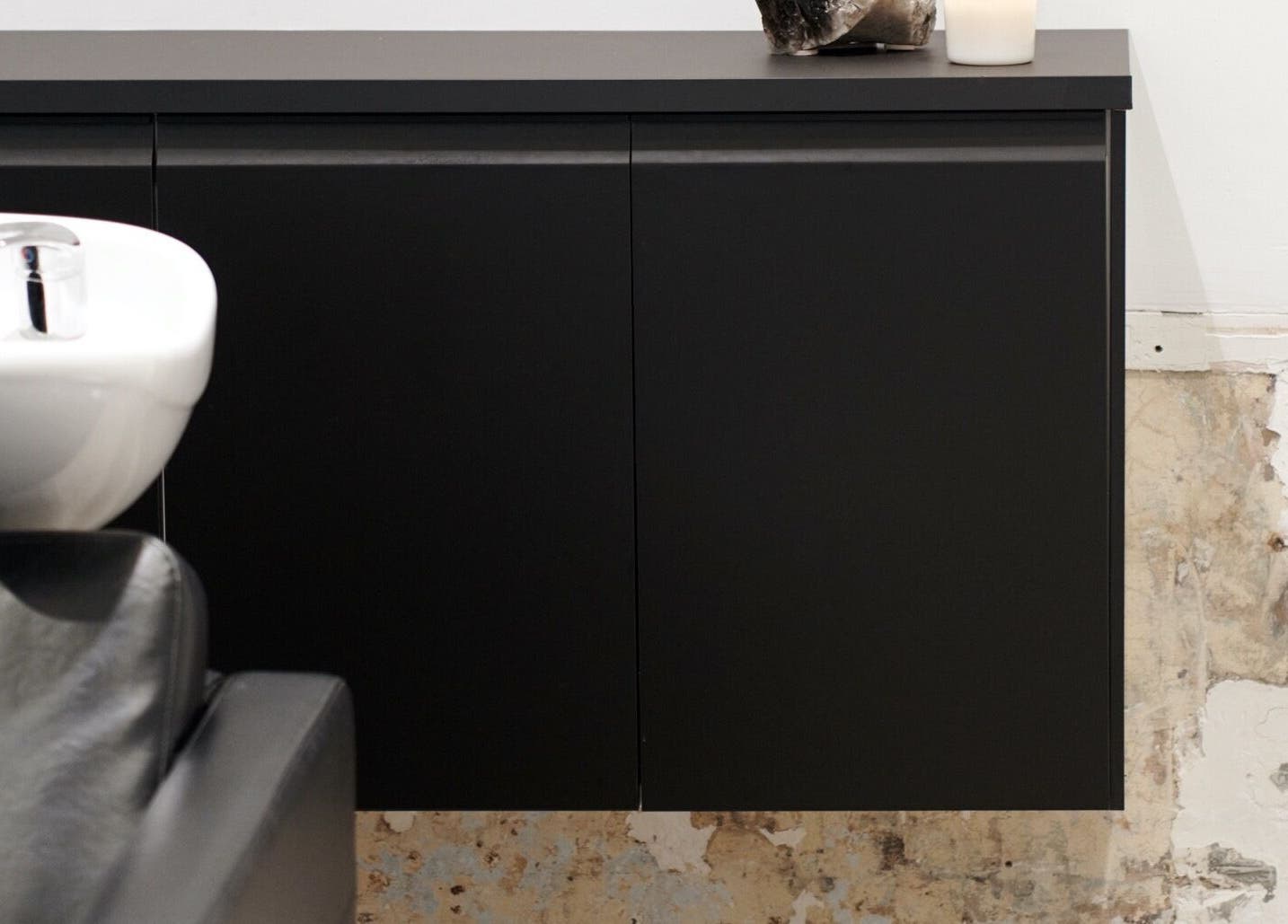 Modern shampoo sink and black cabinet at Vandermeer Hair, Surry Hills, New South Wales, AU.