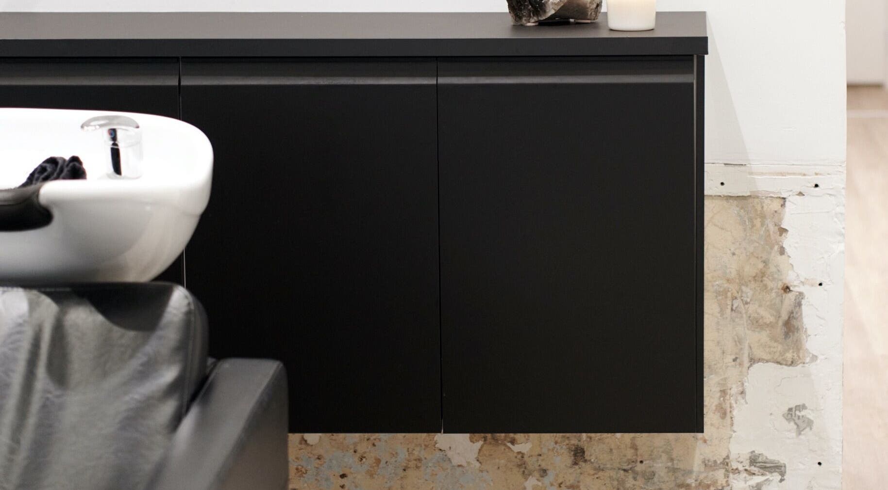 Modern shampoo sink and black cabinet at Vandermeer Hair, Surry Hills, New South Wales, AU.