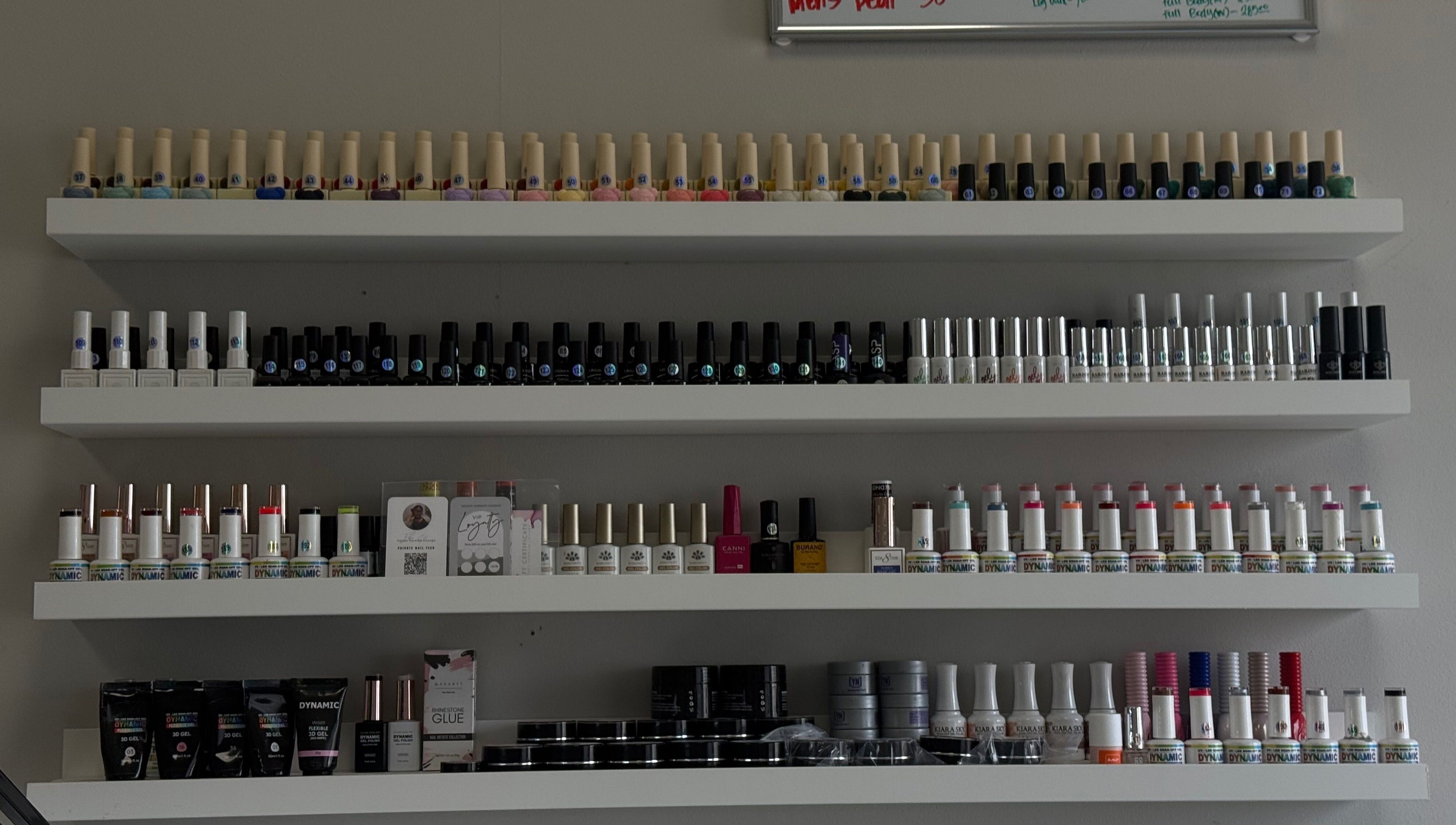 Nail polish shelves at Velvet Varnish Lounge in Spring, Texas, US showcasing a variety of vibrant colors.