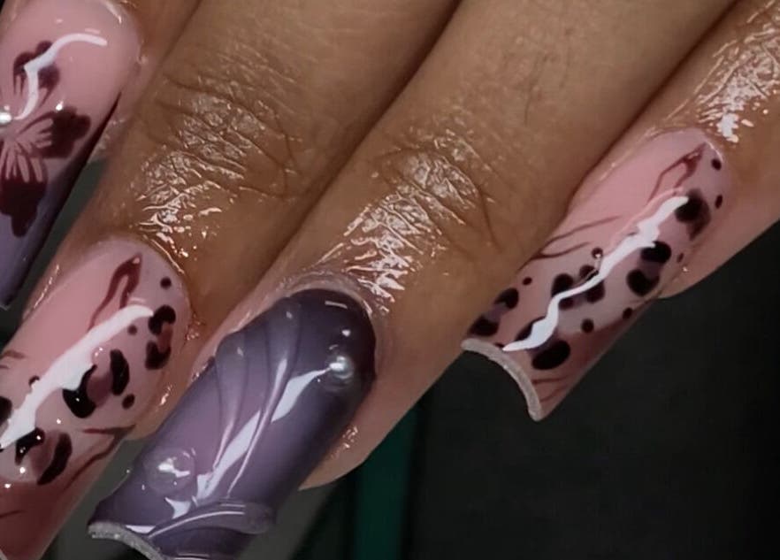 Elegant nail art featuring floral designs at Velvet Varnish Lounge, Spring, Texas, US.