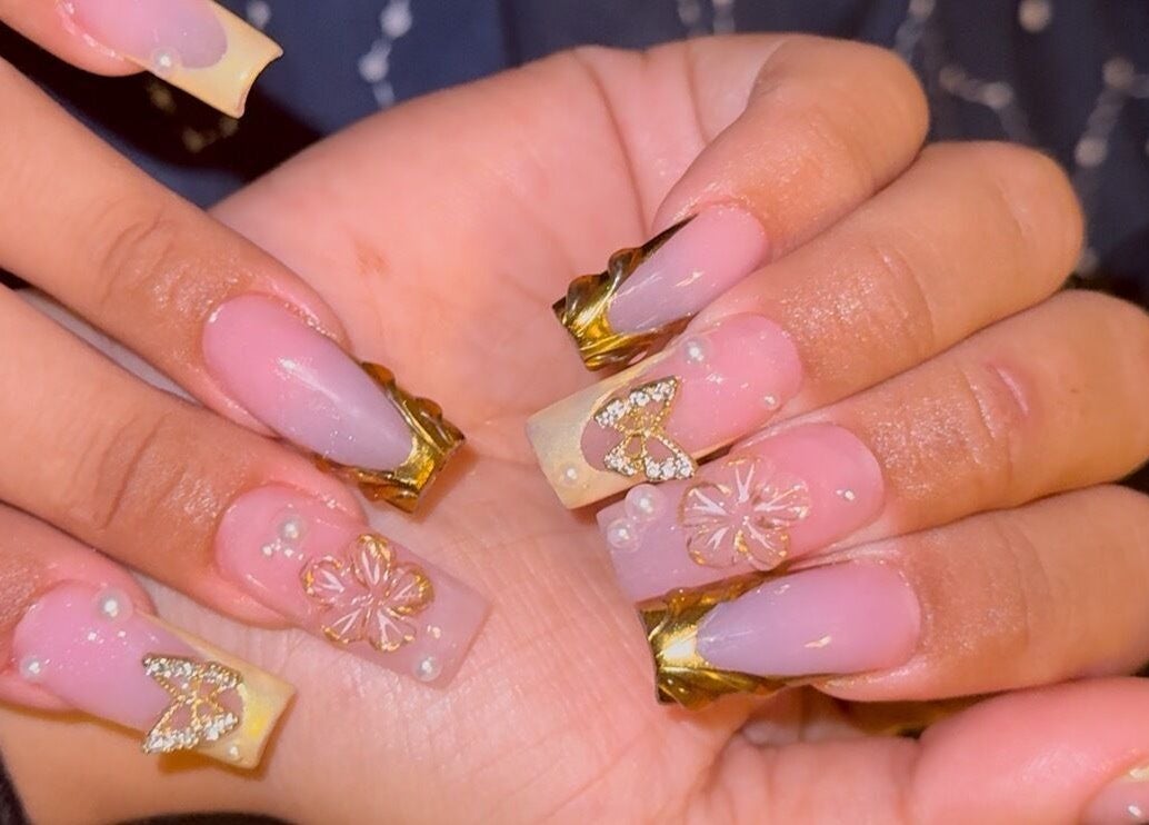 Exquisite nail art with gold accents at Velvet Varnish Lounge, Spring, Texas, US.