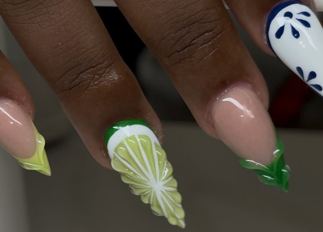 Vibrant lime-inspired nail art at Velvet Varnish Lounge, Spring, Texas, US, showcasing intricate designs.