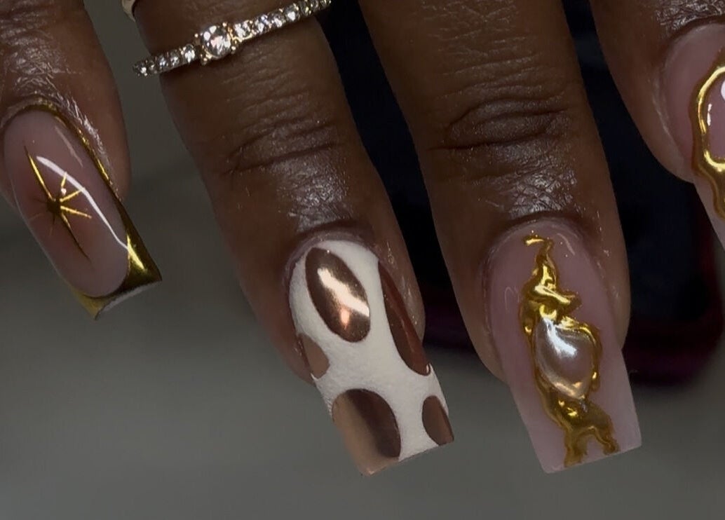 Elegant nail art with gold accents at Velvet Varnish Lounge in Spring, Texas, US.