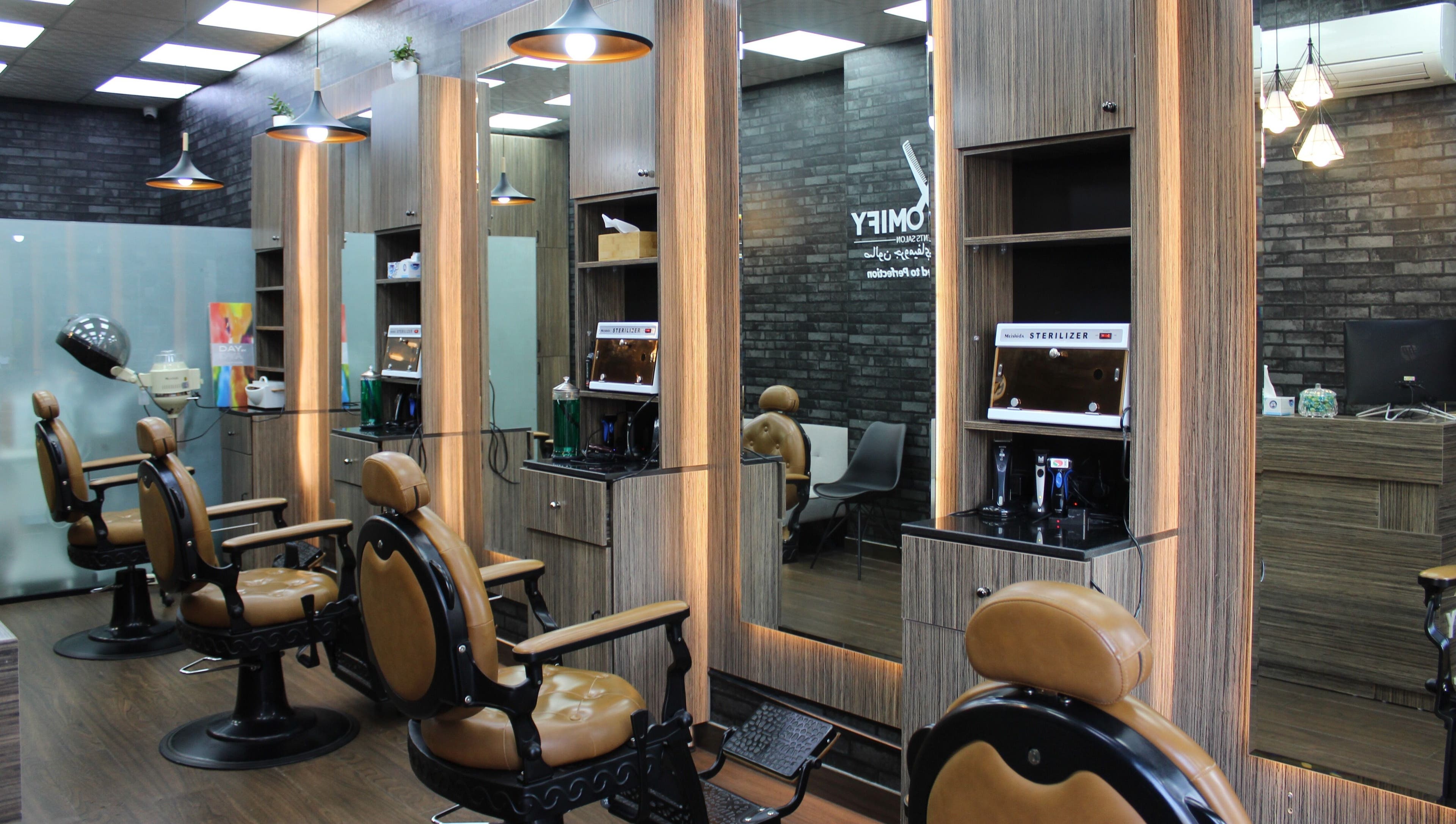 Modern barber chairs in Groomify Gents Salon, Abu Dhabi, AE, showcasing a stylish and inviting atmosphere.