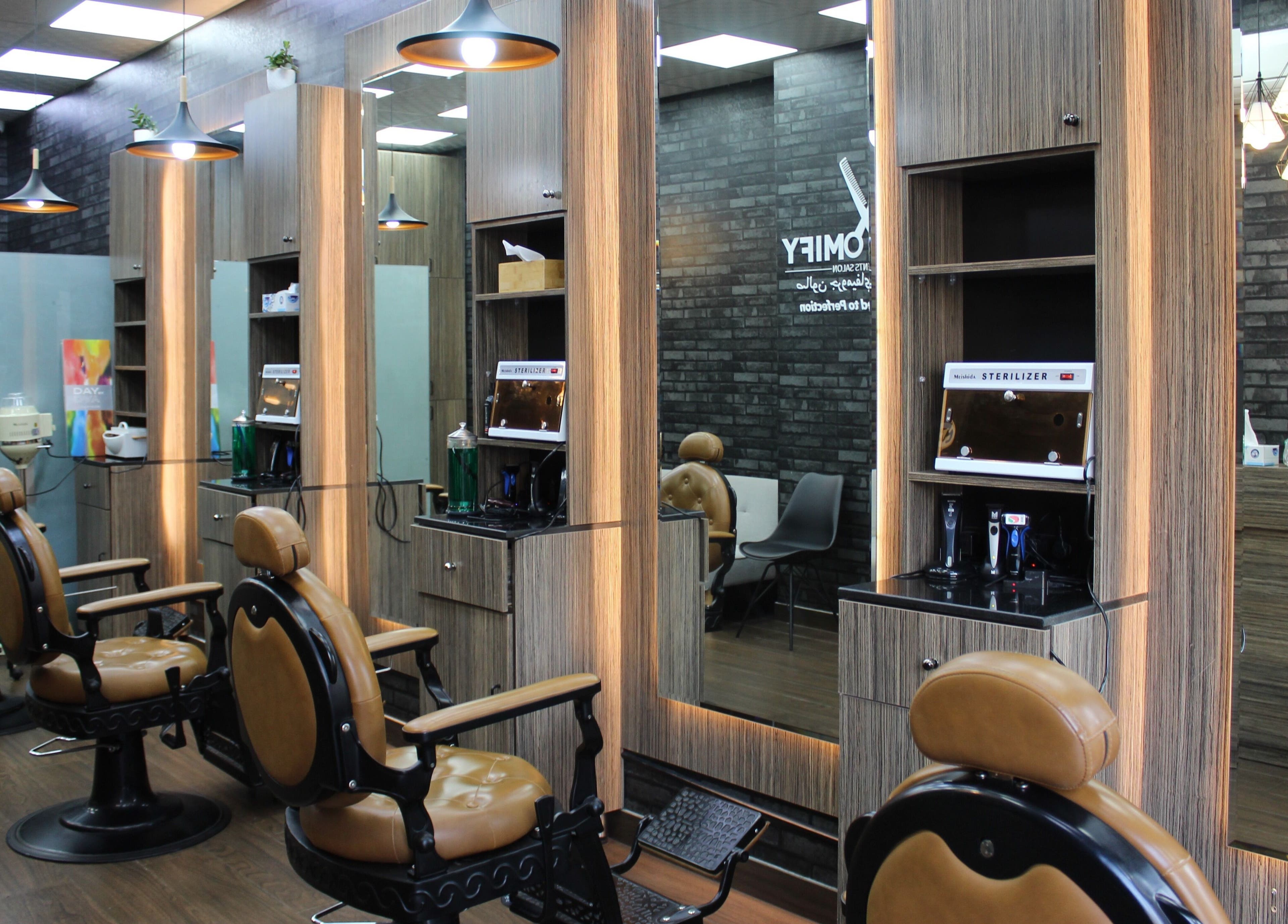 Modern barber chairs in Groomify Gents Salon, Abu Dhabi, AE, showcasing a stylish and inviting atmosphere.