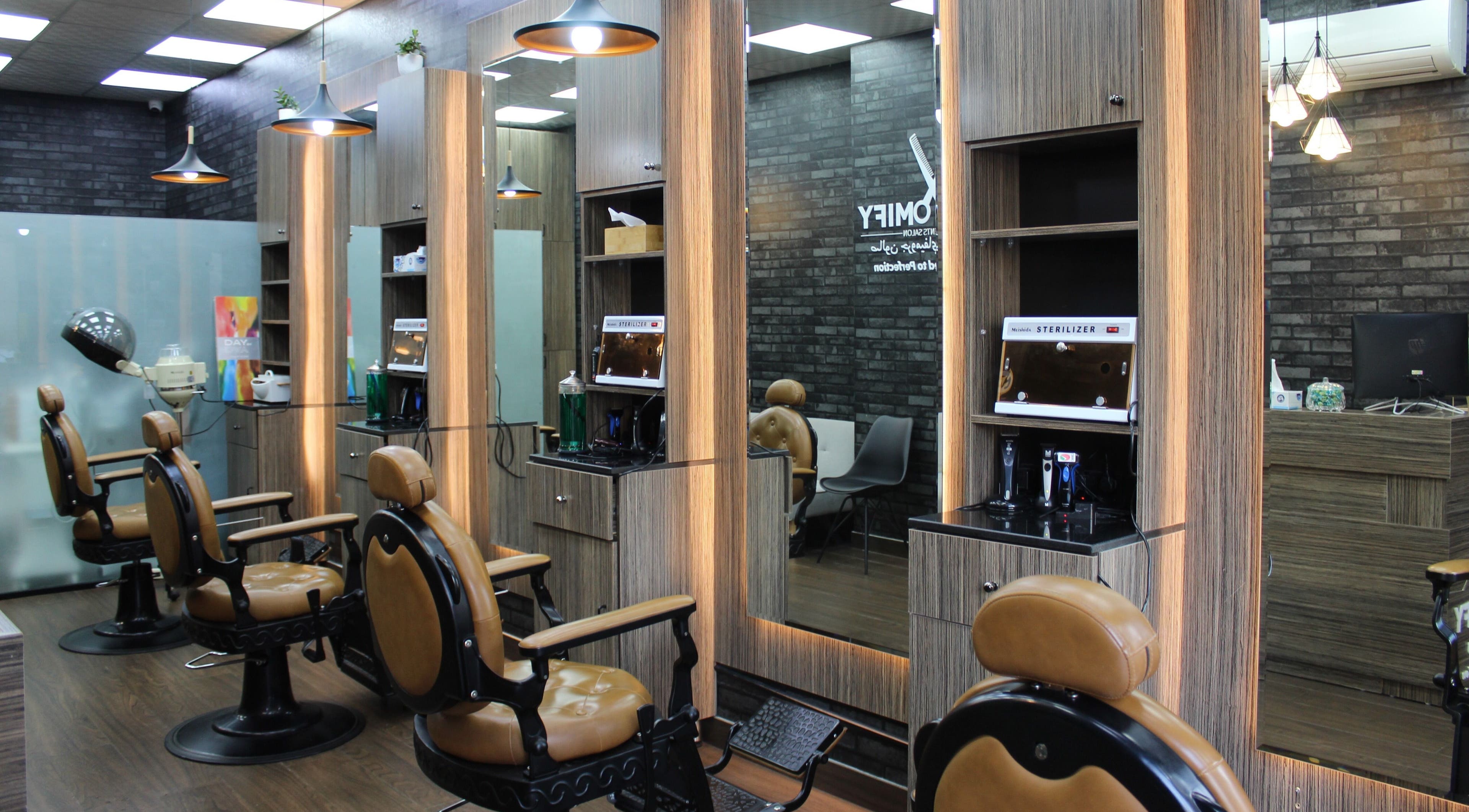 Modern barber chairs in Groomify Gents Salon, Abu Dhabi, AE, showcasing a stylish and inviting atmosphere.