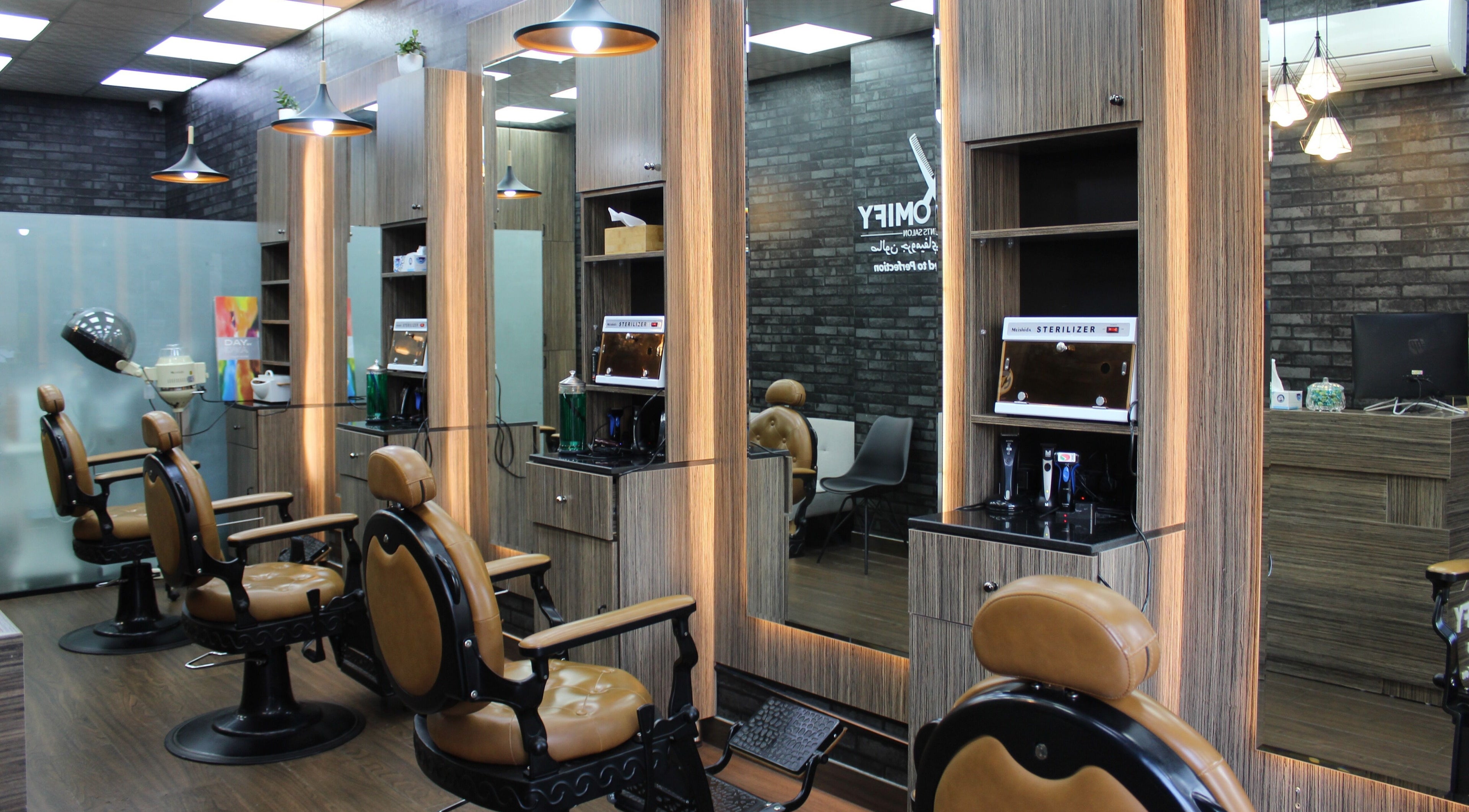 Modern barber chairs in Groomify Gents Salon, Abu Dhabi, AE, showcasing a stylish and inviting atmosphere.