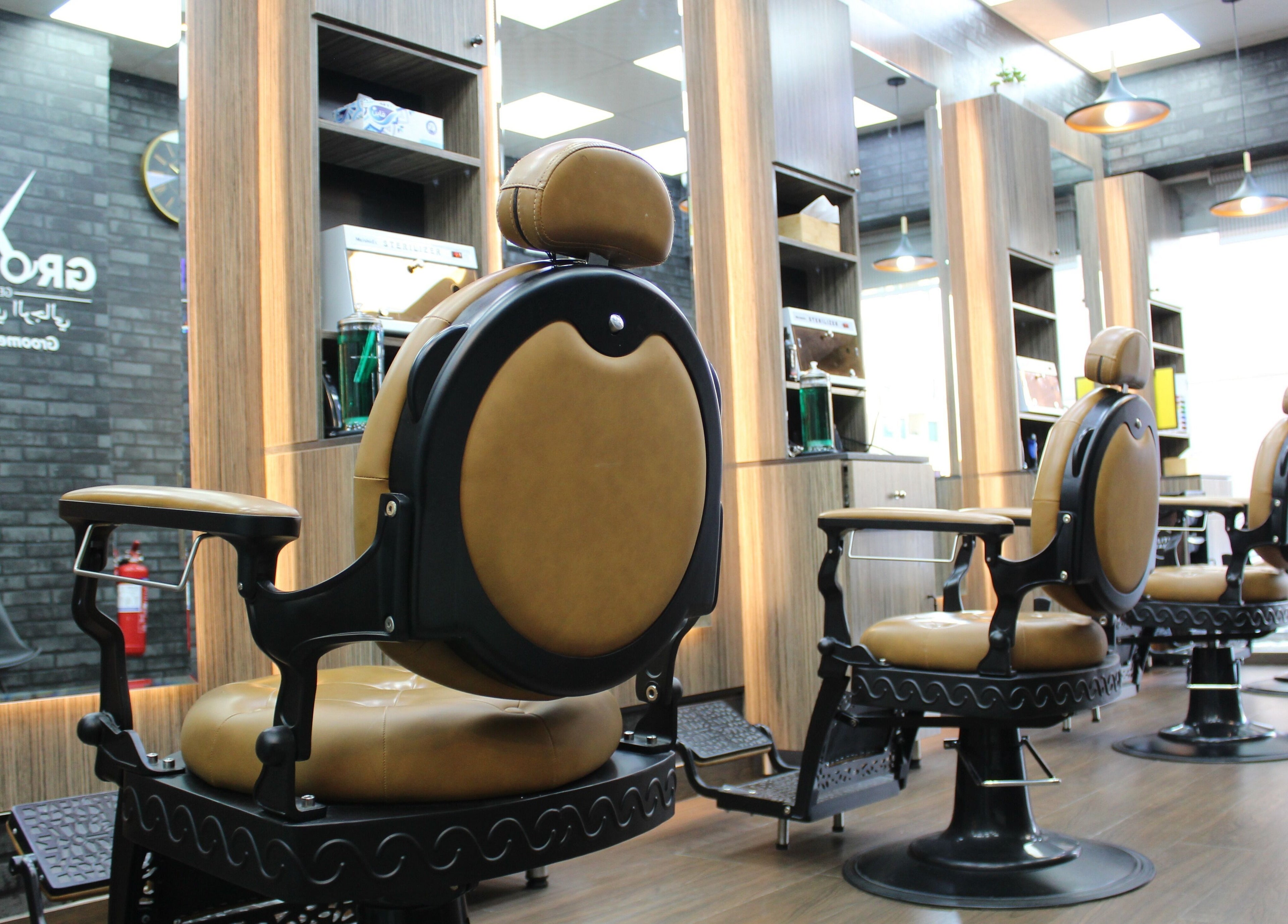 Luxurious barber chairs at Groomify Gents Salon, Abu Dhabi, AE, highlighting modern interior elegance.
