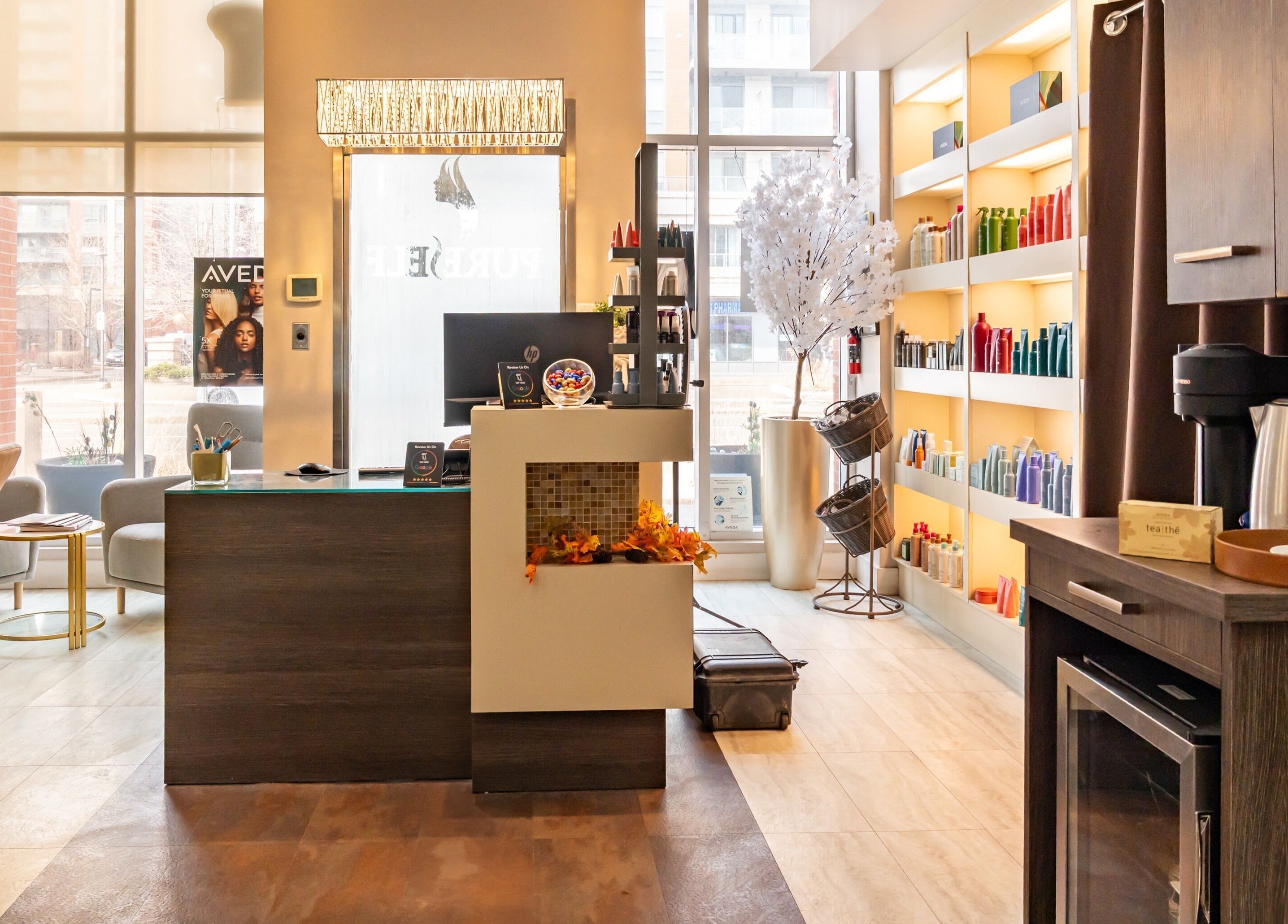 Inviting interior at Pure Self Salon N Spa | AVEDA Salon, Markham, Ontario, CA with modern decor and styling products.