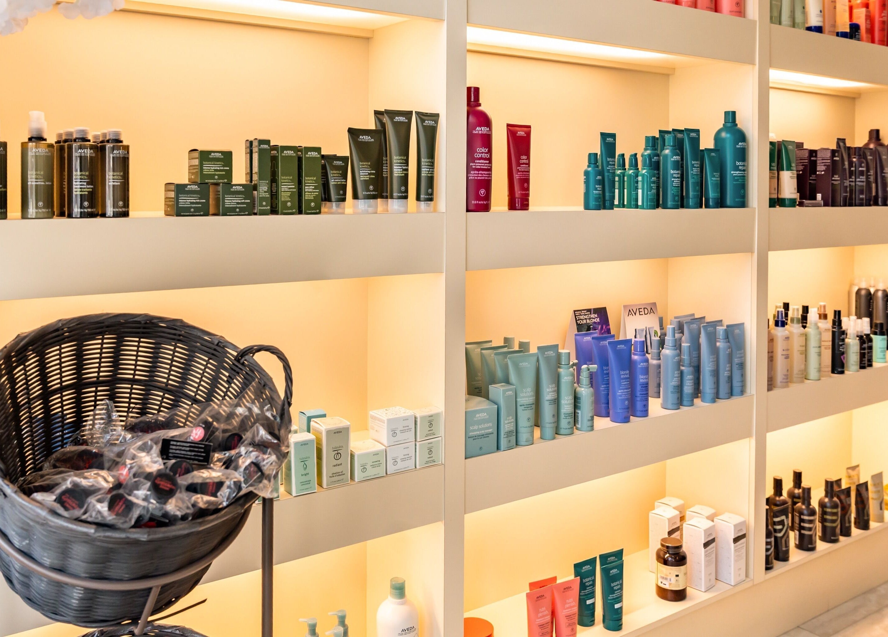 AVEDA products displayed on illuminated shelves at Pure Self Salon N Spa | AVEDA Salon, Markham, Ontario, CA.