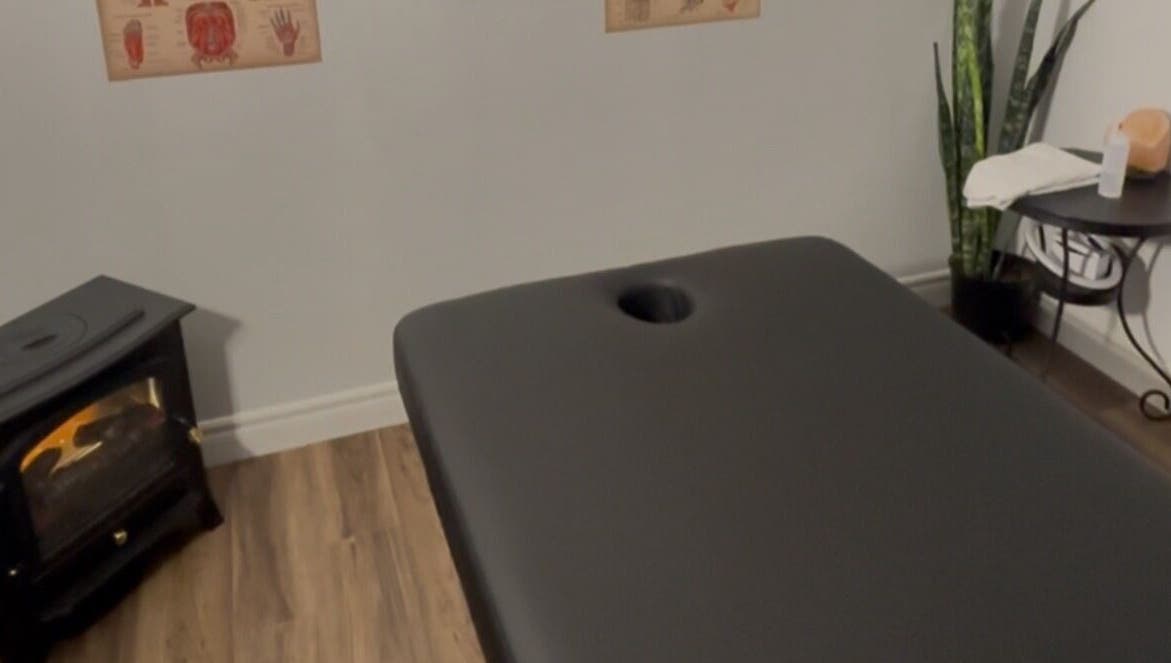 Massage room at Jaiye Health Centre - Ajax Thai Massage, Ajax, Ontario, CA with table, plant, and heater.