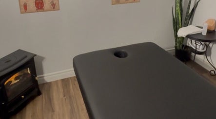 Massage room at Jaiye Health Centre - Ajax Thai Massage, Ajax, Ontario, CA with table, plant, and heater.