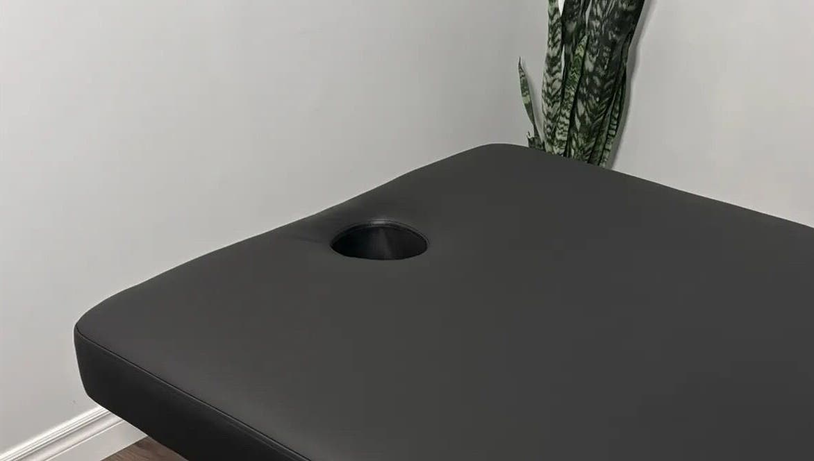 Massage table at Jaiye Health Centre - Ajax Thai Massage in Ajax, Ontario, CA provides comfort for relaxation.