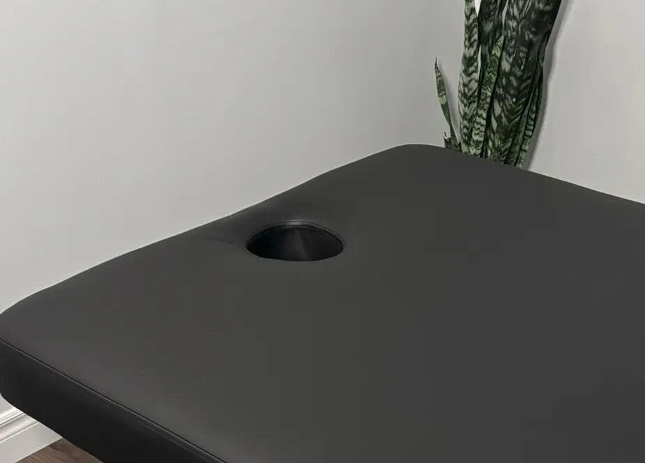 Massage table at Jaiye Health Centre - Ajax Thai Massage in Ajax, Ontario, CA provides comfort for relaxation.