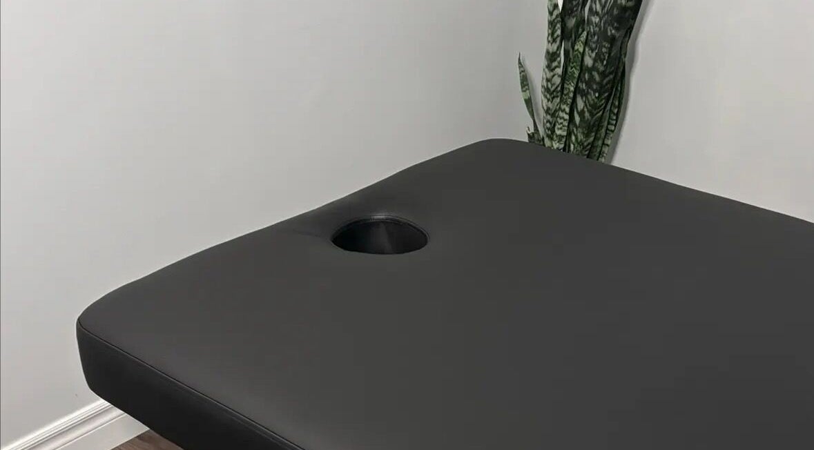 Massage table at Jaiye Health Centre - Ajax Thai Massage in Ajax, Ontario, CA provides comfort for relaxation.