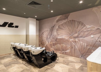 Elegant wash stations at Jts Rockingham salon in Rockingham, Western Australia, AU, with floral wall design.
