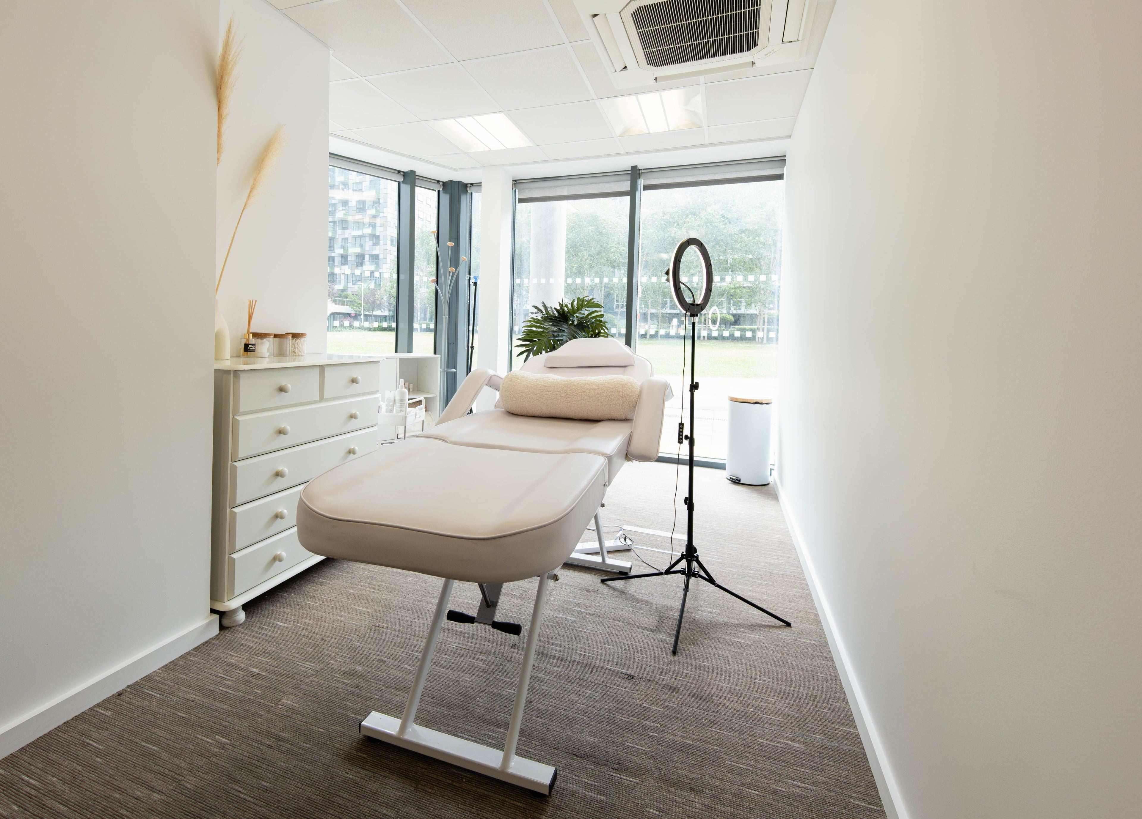 Tranquil treatment room at Fazara Aesthetics in London E14 9DQ, England, GB, featuring a luxurious massage bed.
