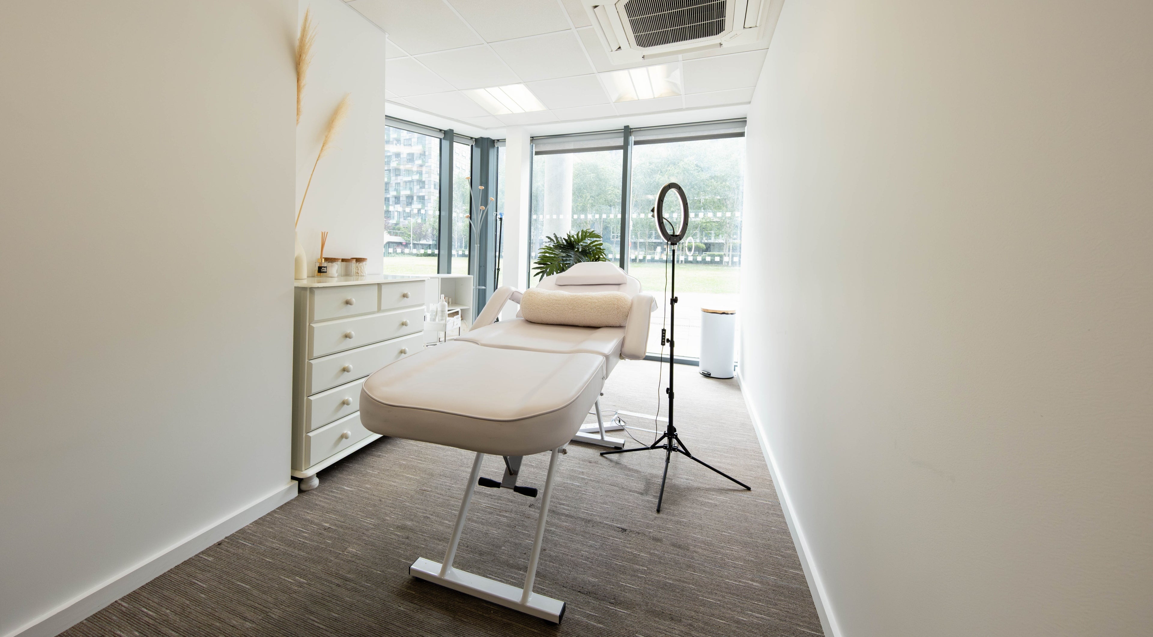 Tranquil treatment room at Fazara Aesthetics in London E14 9DQ, England, GB, featuring a luxurious massage bed.
