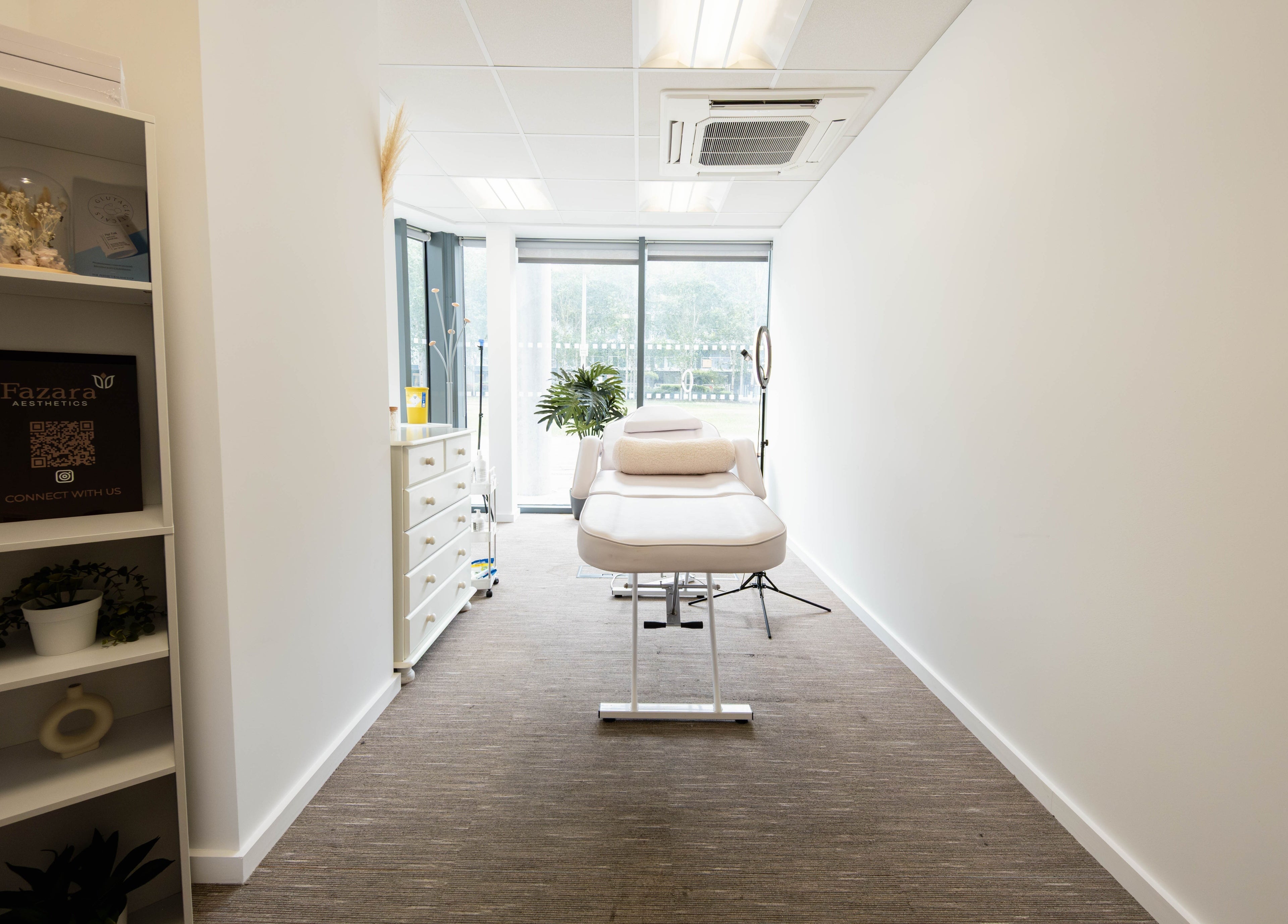 Bright treatment room at Fazara Aesthetics, London E14 9DQ, GB, featuring a comfortable bed and natural decor.