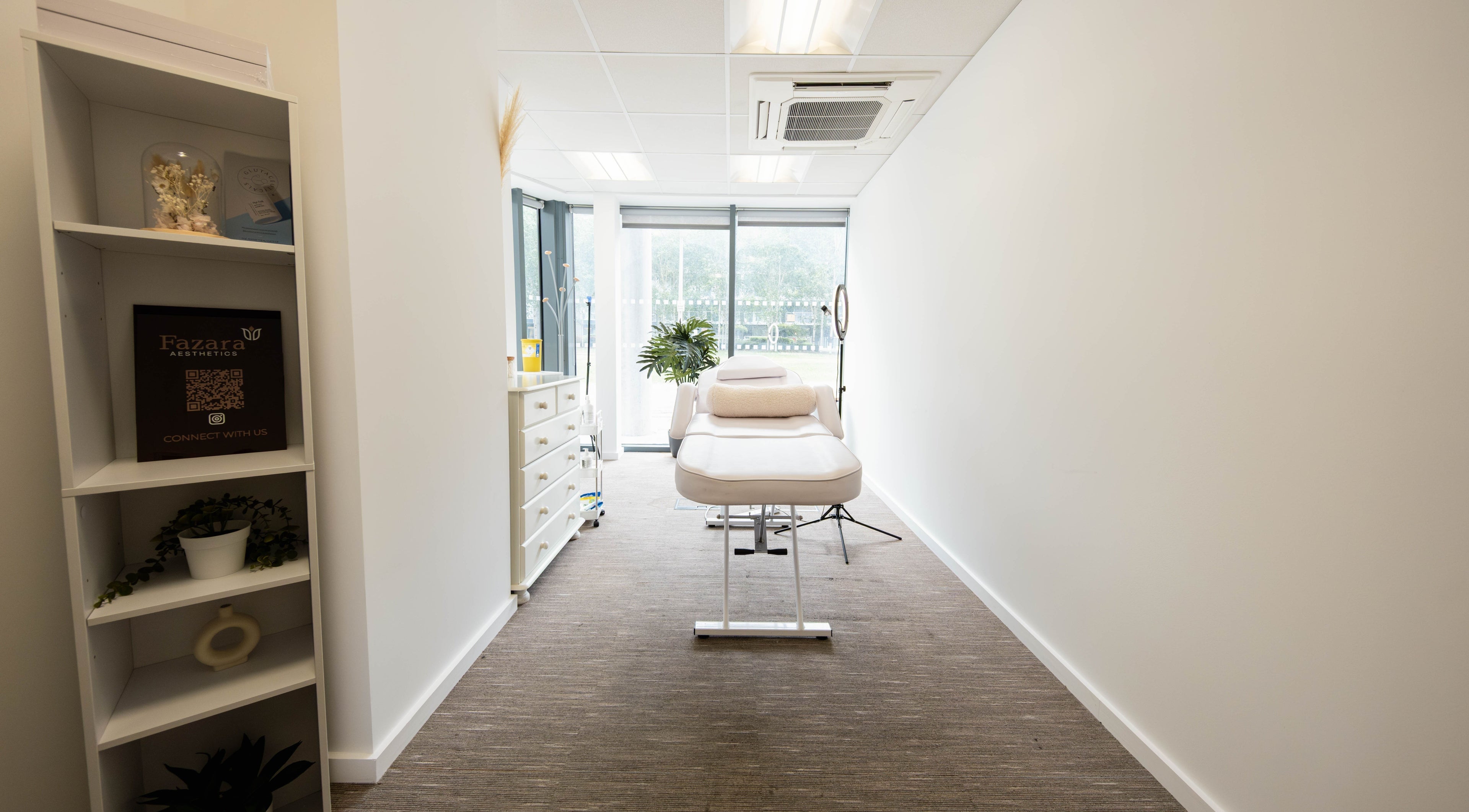 Bright treatment room at Fazara Aesthetics, London E14 9DQ, GB, featuring a comfortable bed and natural decor.