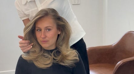A stylist perfecting hair waves at Blondelle Club, Albury, New South Wales, AU.