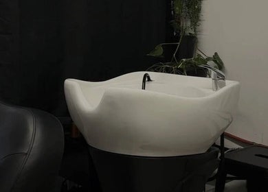 Chic hair wash station at Esthetika Studio, Baulkham Hills, New South Wales, AU. Sleek design with greenery accents.