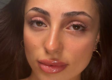 Close-up of a woman's face showing glowing skin and makeup at Esthetika Studio, Baulkham Hills, New South Wales, AU.