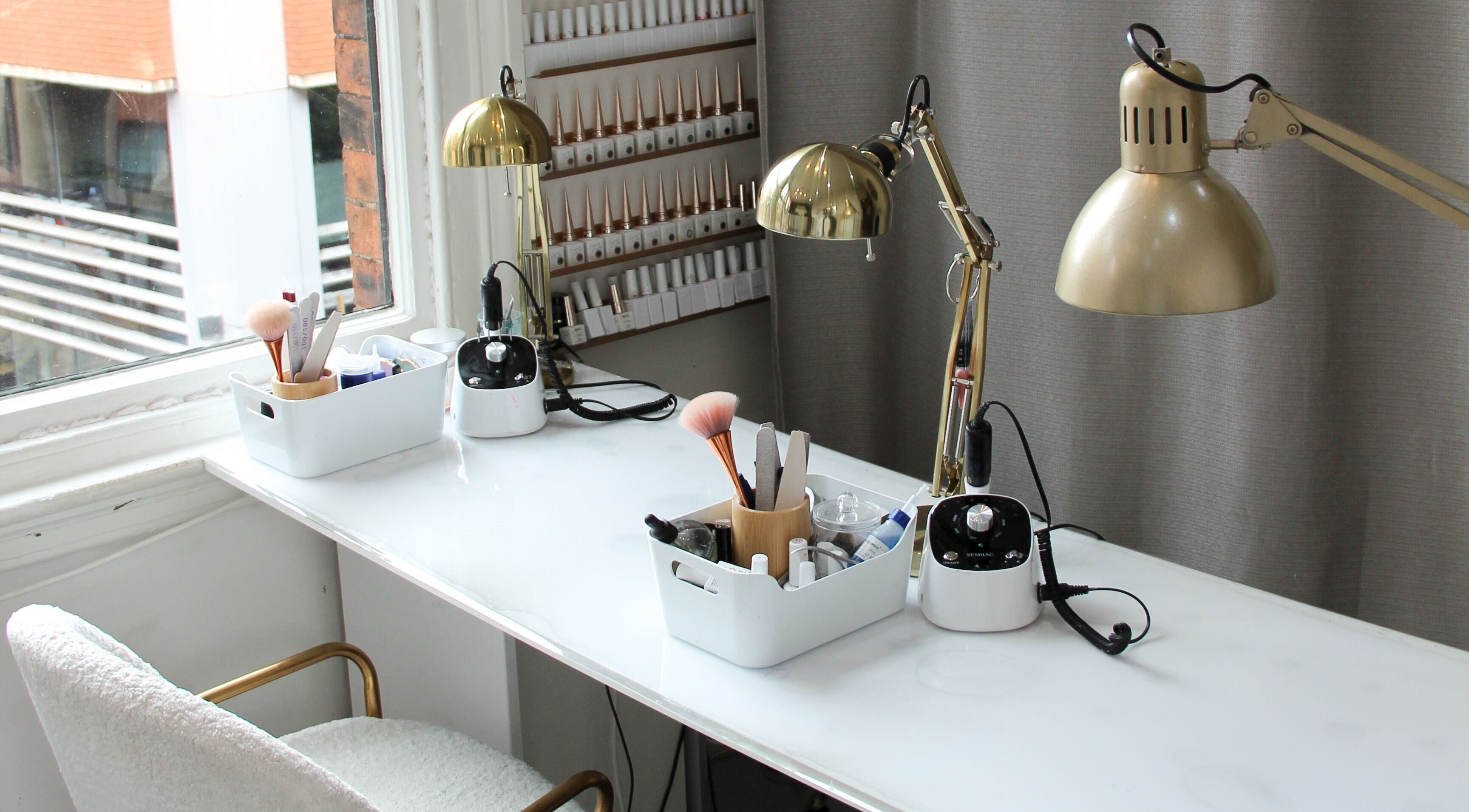 Elegant nail station setup at Nails by Yulia Hamilton in Manchester, England, GB featuring tools and lighting.
