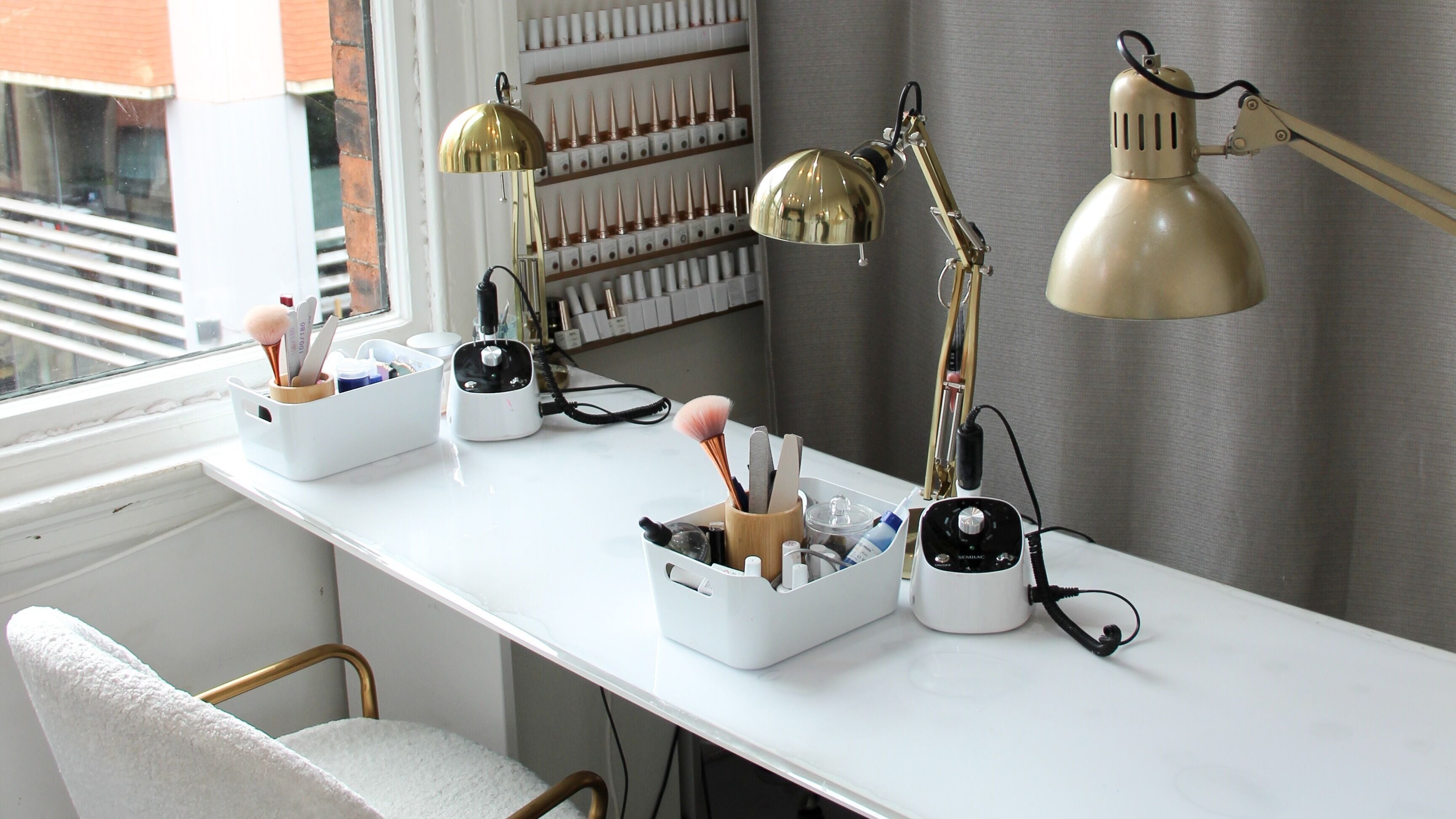 Elegant nail station setup at Nails by Yulia Hamilton in Manchester, England, GB featuring tools and lighting.