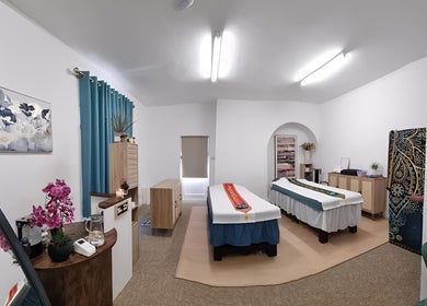 Serene massage room at Chantara Thai Massage, Norwich, England, GB, featuring two massage tables and elegant decor.