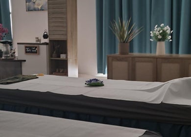 Tranquil massage room at Chantara Thai Massage, Norwich, England, GB with calming decor and fresh flowers.