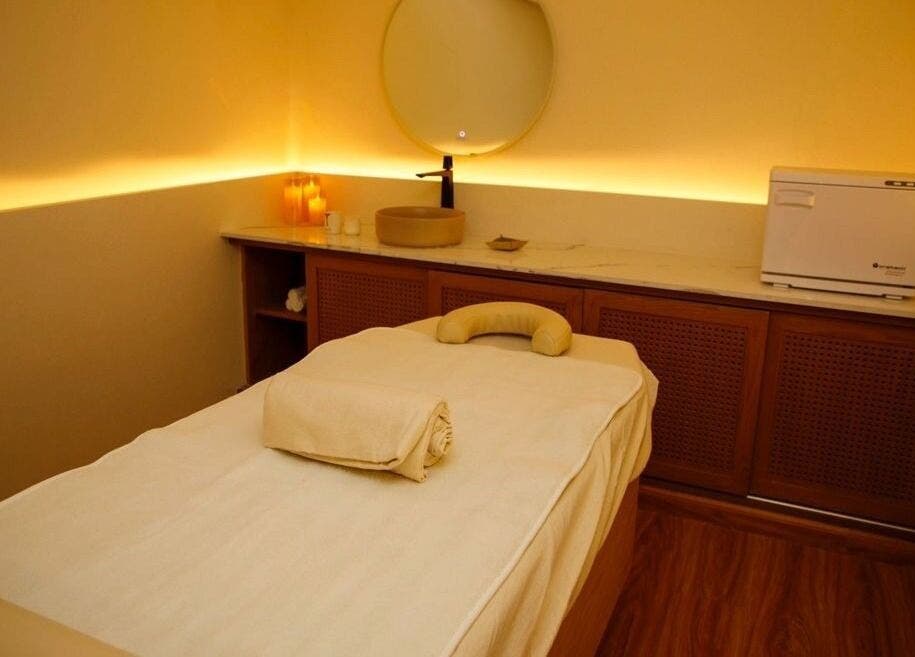 Tranquil massage room at Spa Al Hana I سبا الهنا, Riyadh, Riyadh Province, SA, with warm lighting and plush bed.