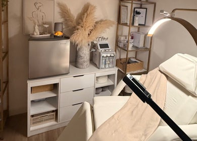 Alla Skin & Aesthetics in Norwich, England, GB features a tranquil treatment room with elegant decor and plush spa bed.