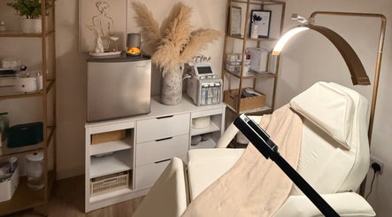 Alla Skin & Aesthetics in Norwich, England, GB features a tranquil treatment room with elegant decor and plush spa bed.