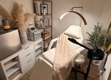 Cozy treatment room at Alla Skin & Aesthetics, Norwich, England, GB, featuring a modern spa chair and decor.