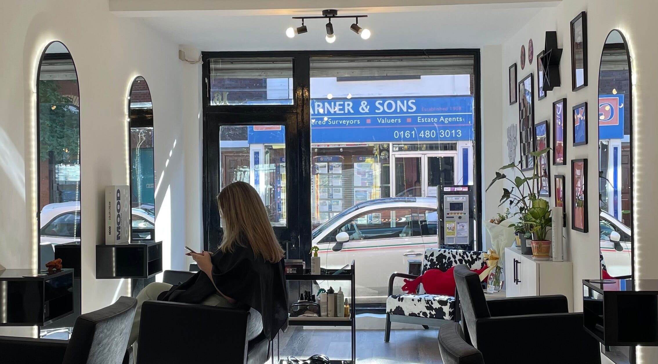 Modern interior of The Crescent Hair Studio in Stockport, England, GB, showcasing sleek decor and styling chairs.